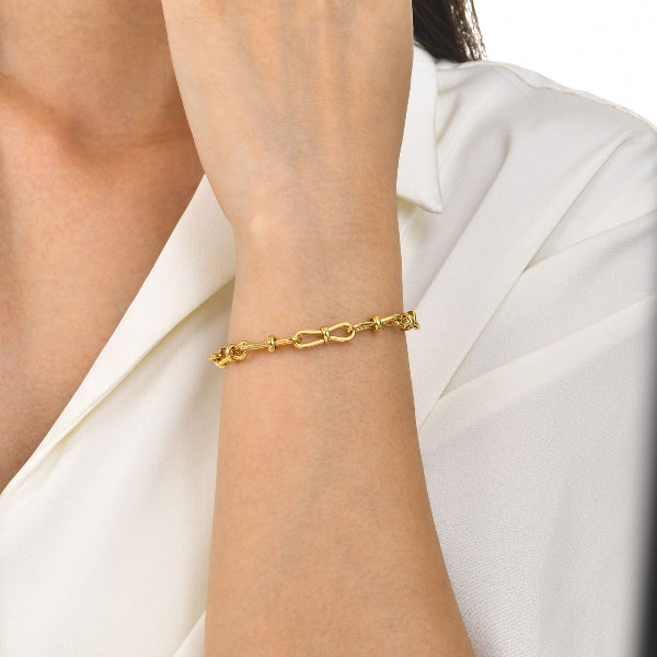 Bracelet doré pour femme avec chaîne torsadée et nœud central, au style chic et intemporel – Alberto Bijoux