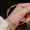 Jonc rigide torsadé doré de 60mm pour femme, au style chic, brillant et tendance – Alberto Bijoux