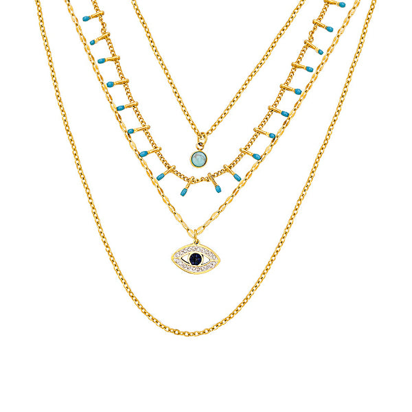 Collier doré avec pendentif œil bleu et pierres turquoises, style protecteur et spirituel, présenté sur fond blanc