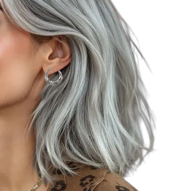 Créoles torsadées argent en acier inoxydable avec finition brillante sculptée.